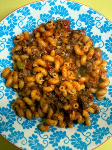 A plate of pasta with meat and vegetables, a delicious and nutritious meal option.