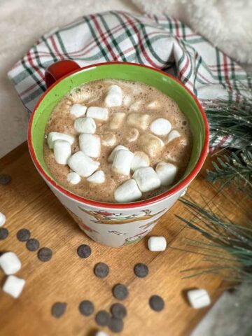 Cup of hot chocolate topped with marshmallows.