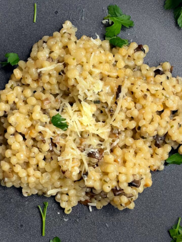 Pearl couscous in an herbed white wine sauce with mushrooms and cilantro.