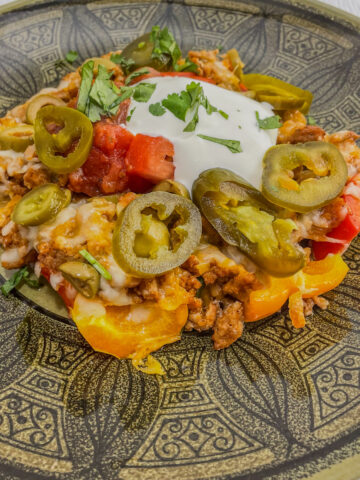 Sweet bell peppers covered in melted cheese, ground beef and olives.